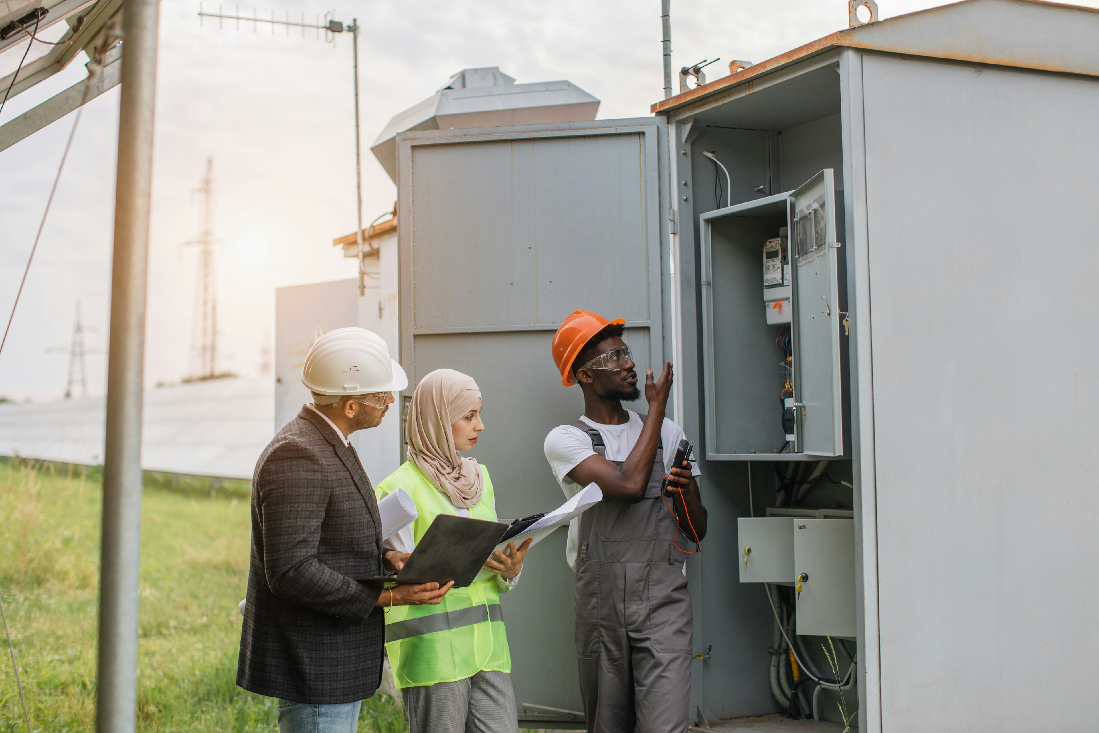 Image of workers inspecting an electrical panel